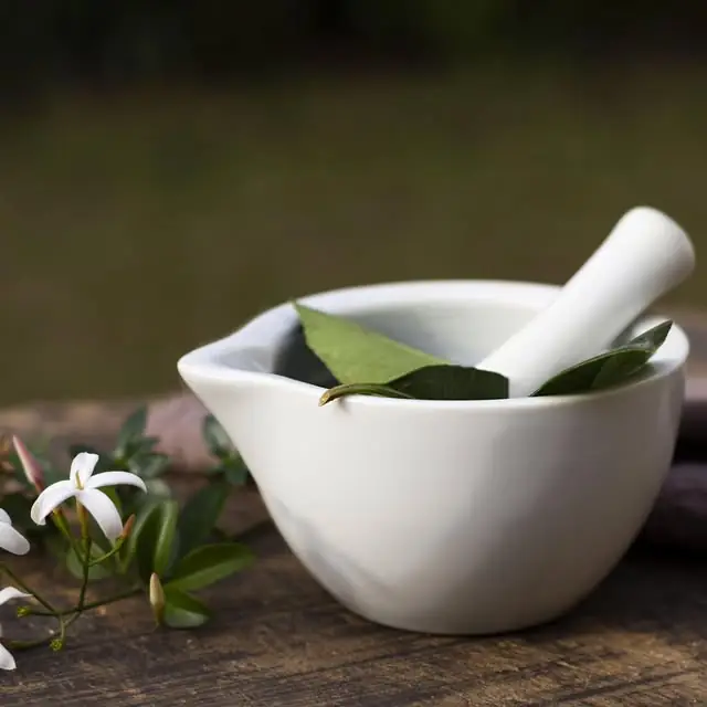 Mortar and pestle with herbs and petals